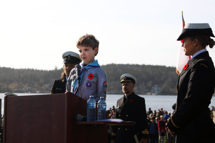 Fraser Grandy speaks at the podium during Friday's Remembrance Day ceremony at Point Pleasant Park.