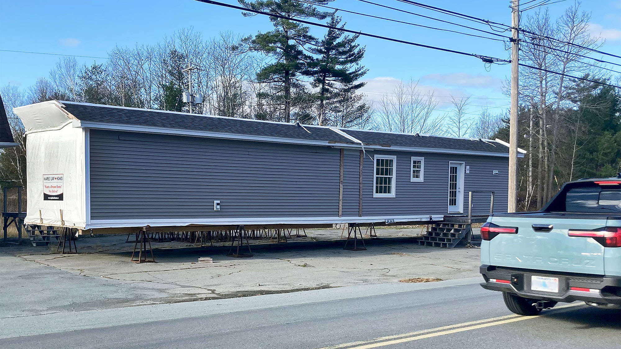 A mobile home propped up alongside a road.