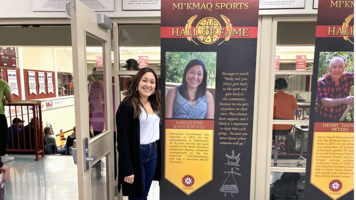 Sara-Lynne Knockwood, from Sipekne’katik First Nation, poses with her Mi'kmaq Sports Hall of Fame banner on Wednesday. In 2016, she was one of the hall's first inductees following a taekwondo career where she won multiple international tournaments.