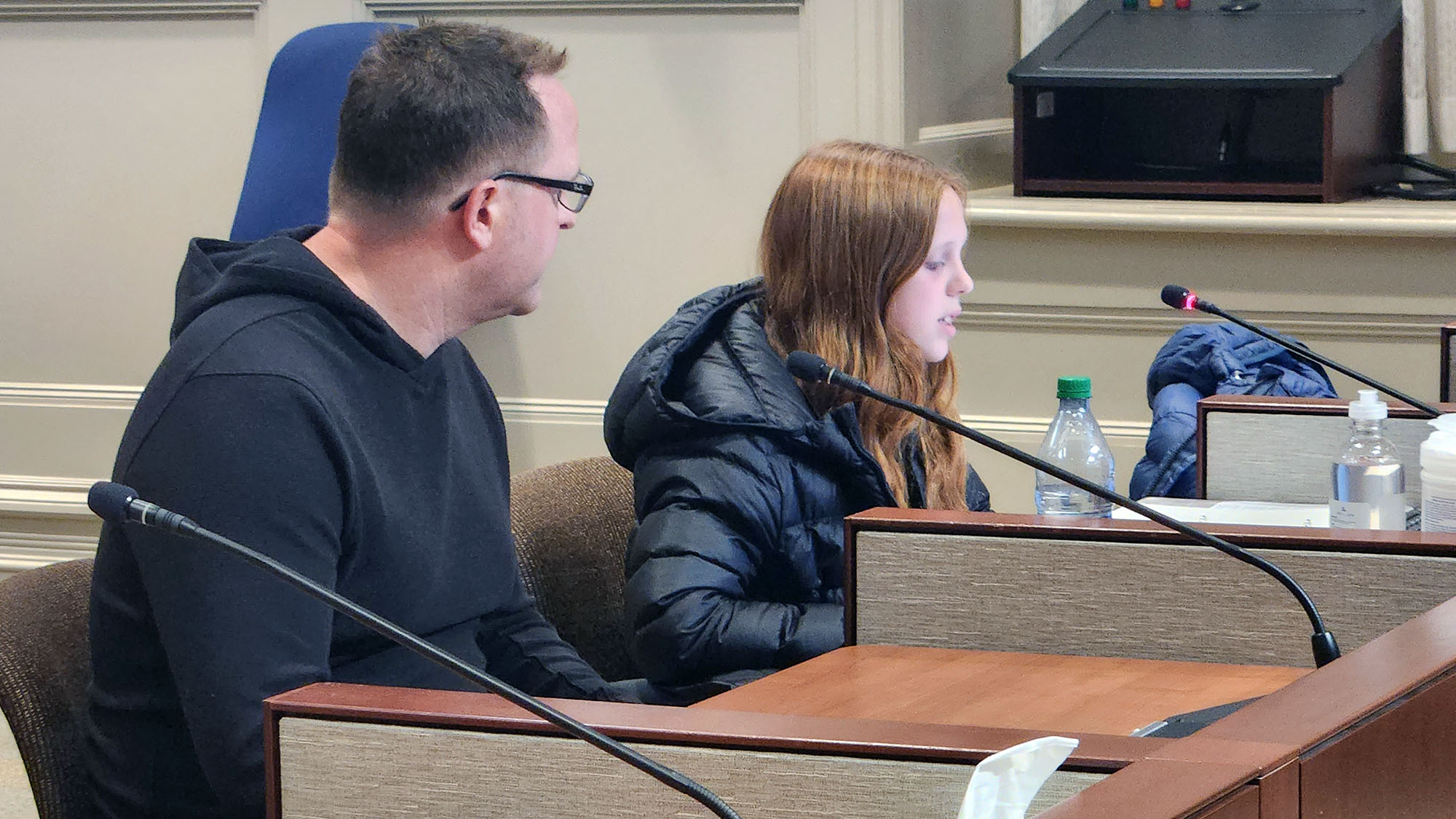 Kristian Curran and daughter Charmonix speak to community council about illegal street parties Tuesday evening.