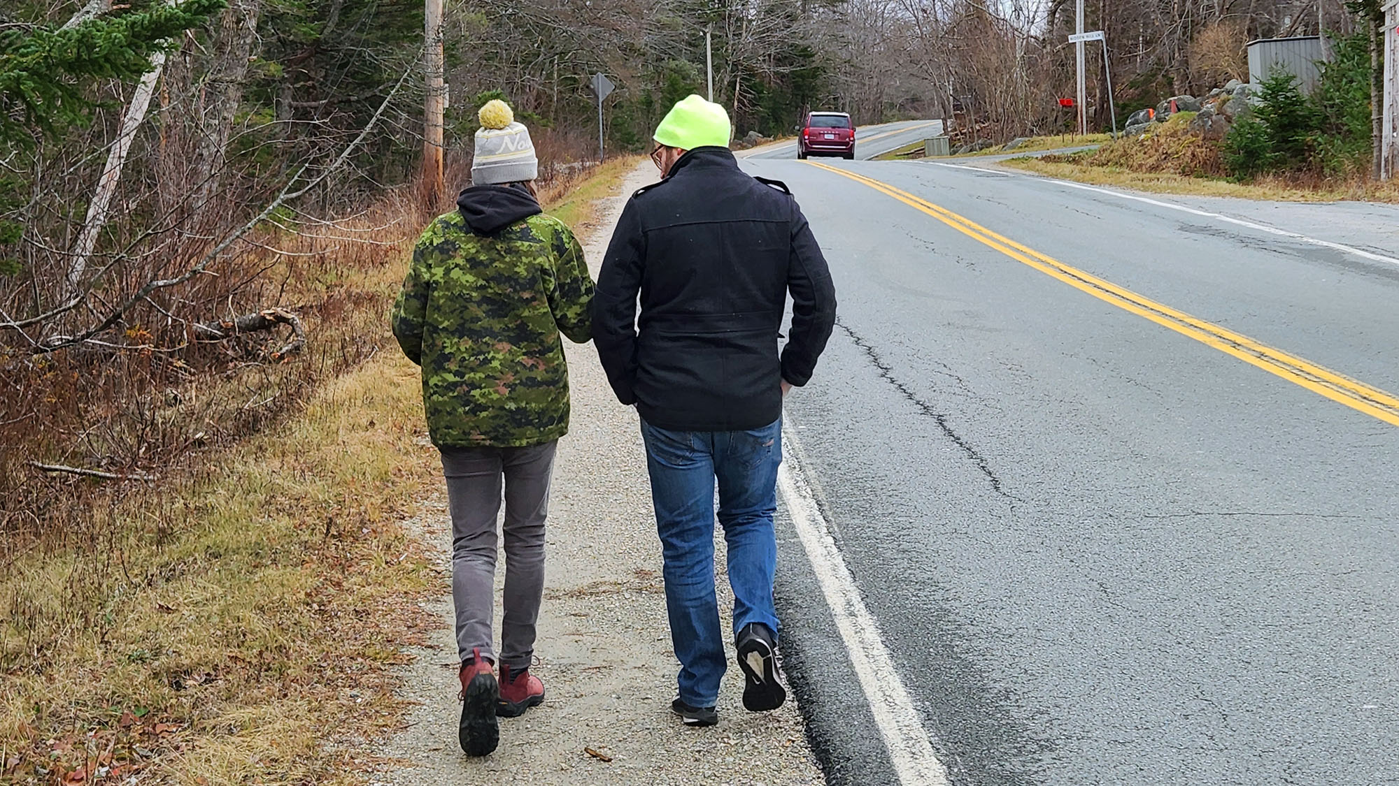 Erin Careless and Matthew Morash walk on the narrow shoulder of Highway 329 in Hubbards.