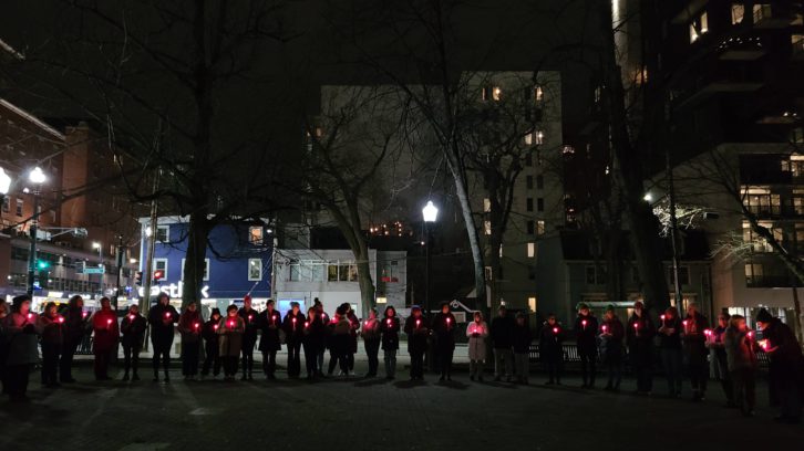 Attendees at this year’s vigil for the National Day of Remembrance and Action to End Gender-based Violence formed a circle to hear opening remarks and a prayer from elder Marlene Companion.