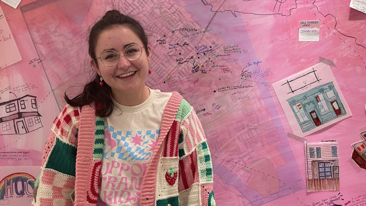 Renée Brazeau stands in front of her evolving map that identifies queer-friendly spaces in Halifax. 