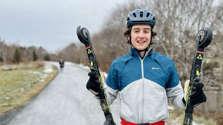 N.S. cross-country ski athlete Cohen Norman holds up his roller skis during a training session on the Chain Lake Trail, Wednesday.
