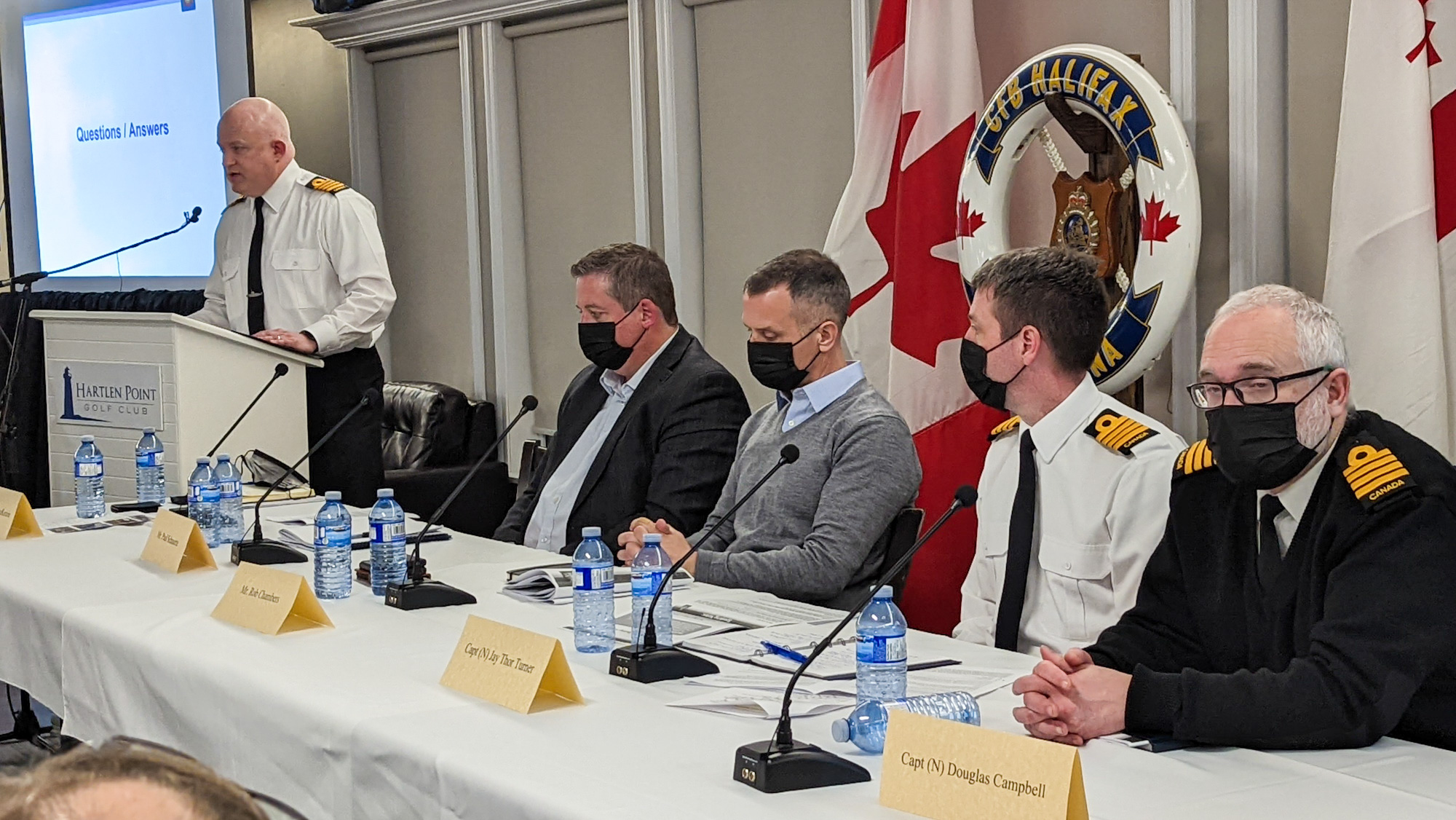 Officials address the crowd at a public meeting on a proposed DND facility last week. Left to right are Capt. Andy MacKenzie, base commander CFB Halifax; Paul Schauerte, director of DND construction project delivery; Rob Chambers, assistant deputy minister of infrastructure and environment; Capt. Jay Thor Turner, CSC deputy project manager; and Capt. Douglas Campbell, director of naval major projects. 