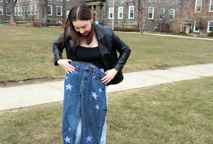 Dalhousie University student Laura Colford holds a pair of jeans she made in her upcycling class. This is one hobby she has to take her mind off the stresses of being a young adult in Halifax -- not only school but affording to live in the city at all.