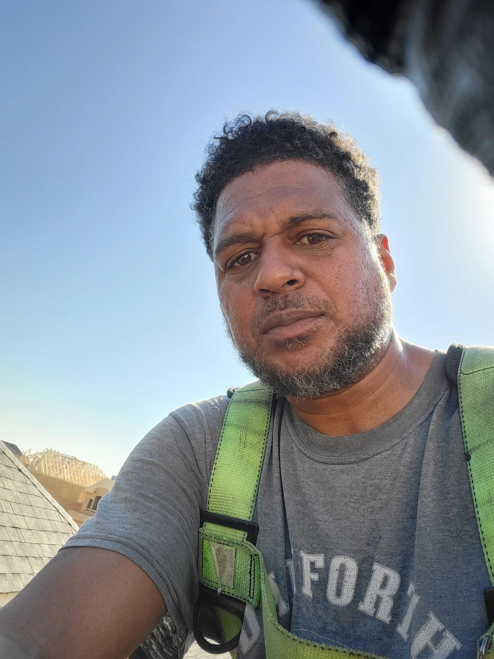 Julian Dean snaps a photo of himself on top of a roof he is working on in Ontario. 