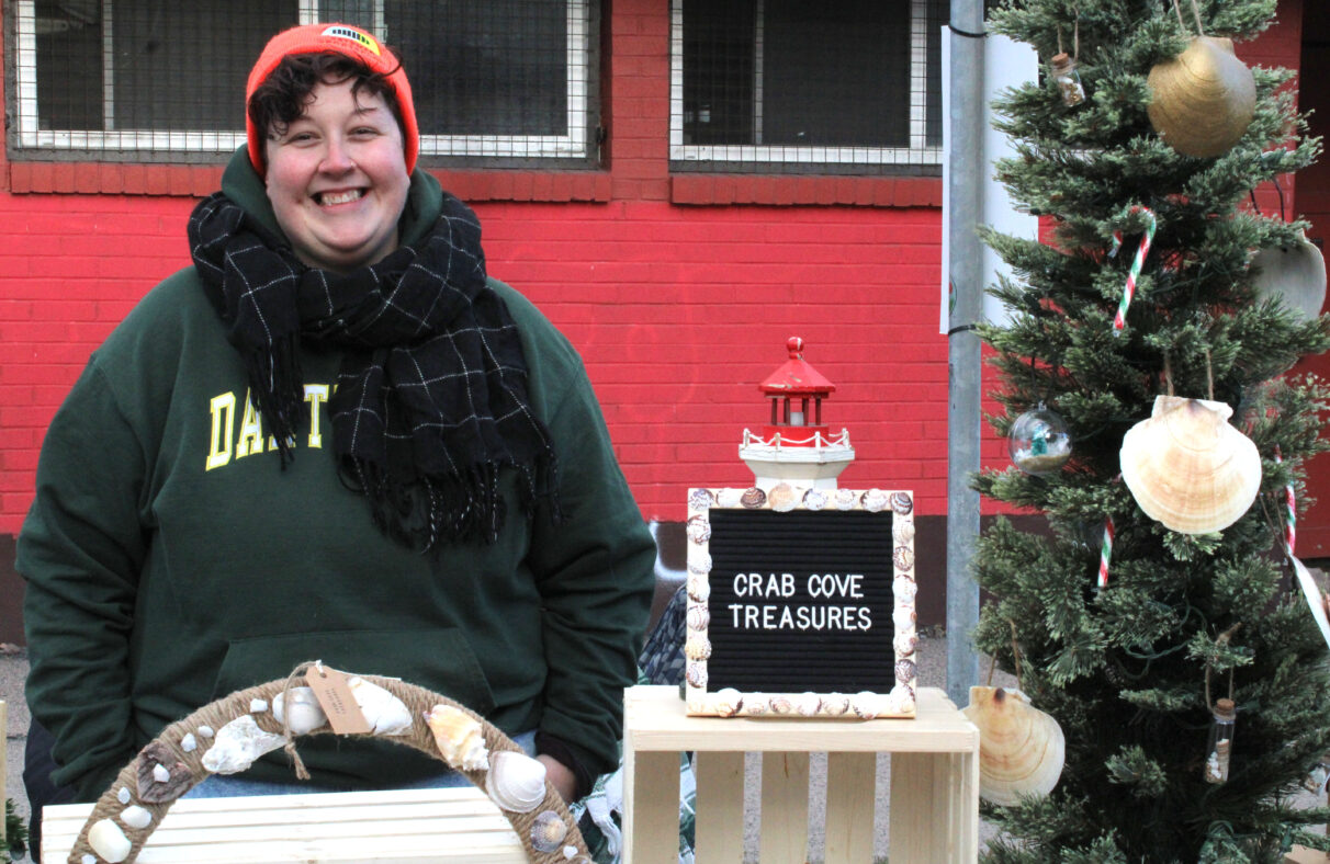 Lindsay Dauphinee of Crab Cove Treasures smiles at her vendor stand.