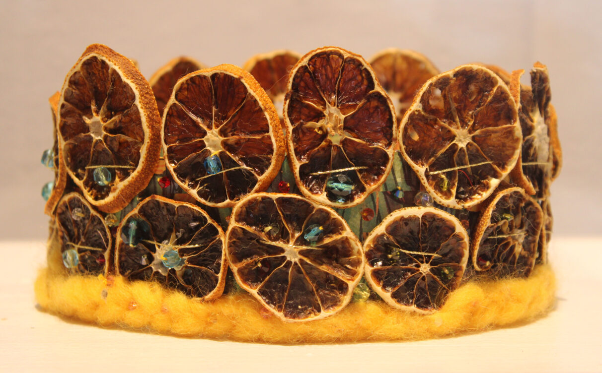 A crown made out dehydrated orange slices, crystals, and wool.