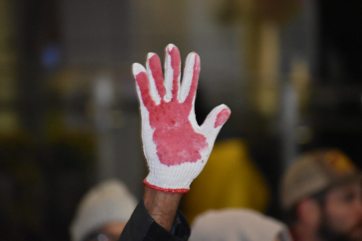 Close up of a white glove with red paint