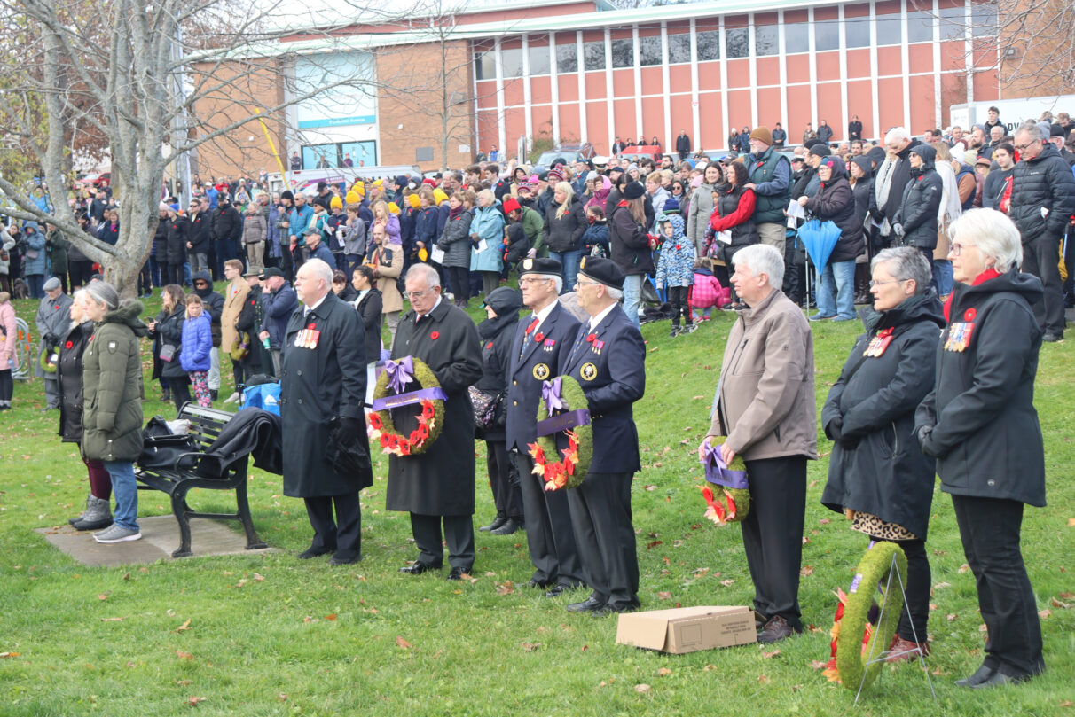 A crowd watches as the ceremony for Remembrance Day 2023 unfold at Sullivan's Pond in Dartmouth, N.S.