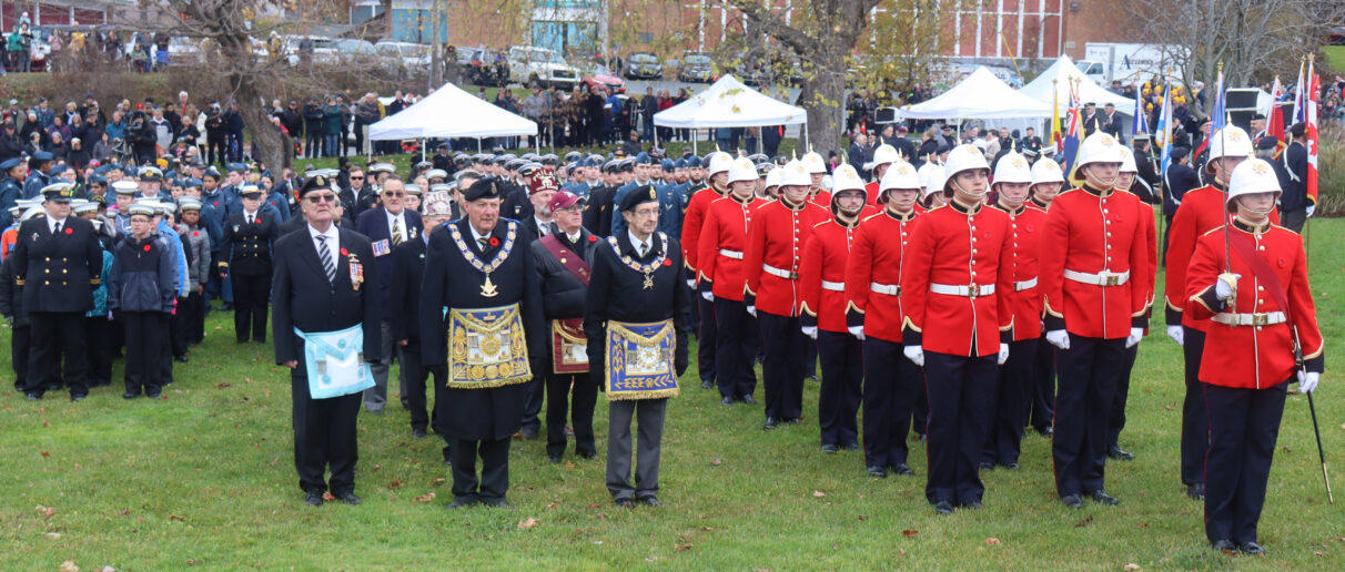 The RCMP, Canadian Armed Forces veterans and cadets stand in Sullivan's Pond in Dartmouth, N.S.