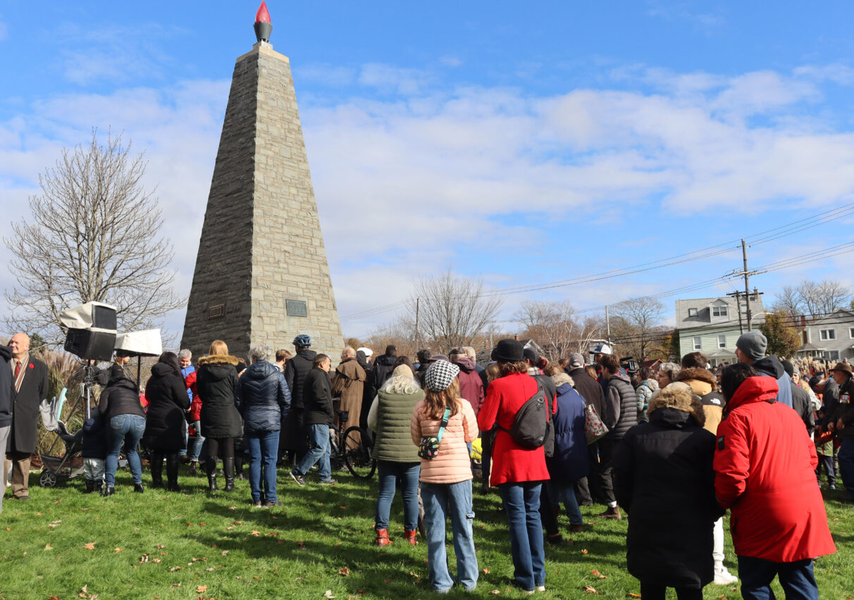 A large crowd makes its way to the cenotaph to place their wreaths on it for Remembrance Day at Sullivan's Pond.
