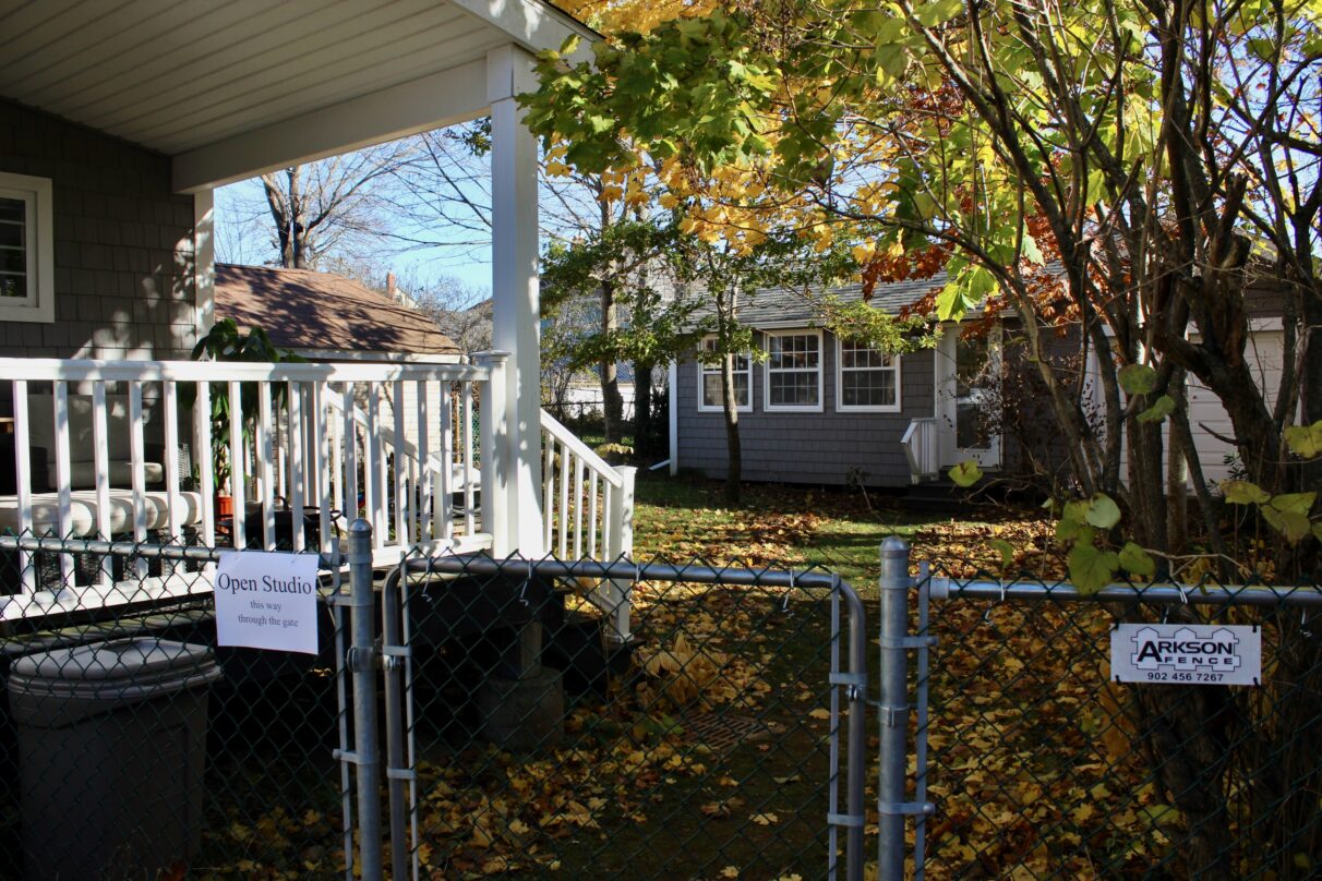 Sign on gate reads "open studio".