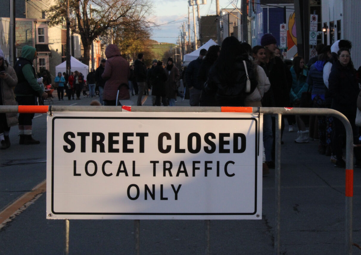 A metal barricade holds a sign that reads "Street Closed Local Traffic Only."