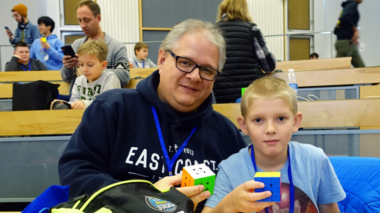 father and son competing together at speedcubing event