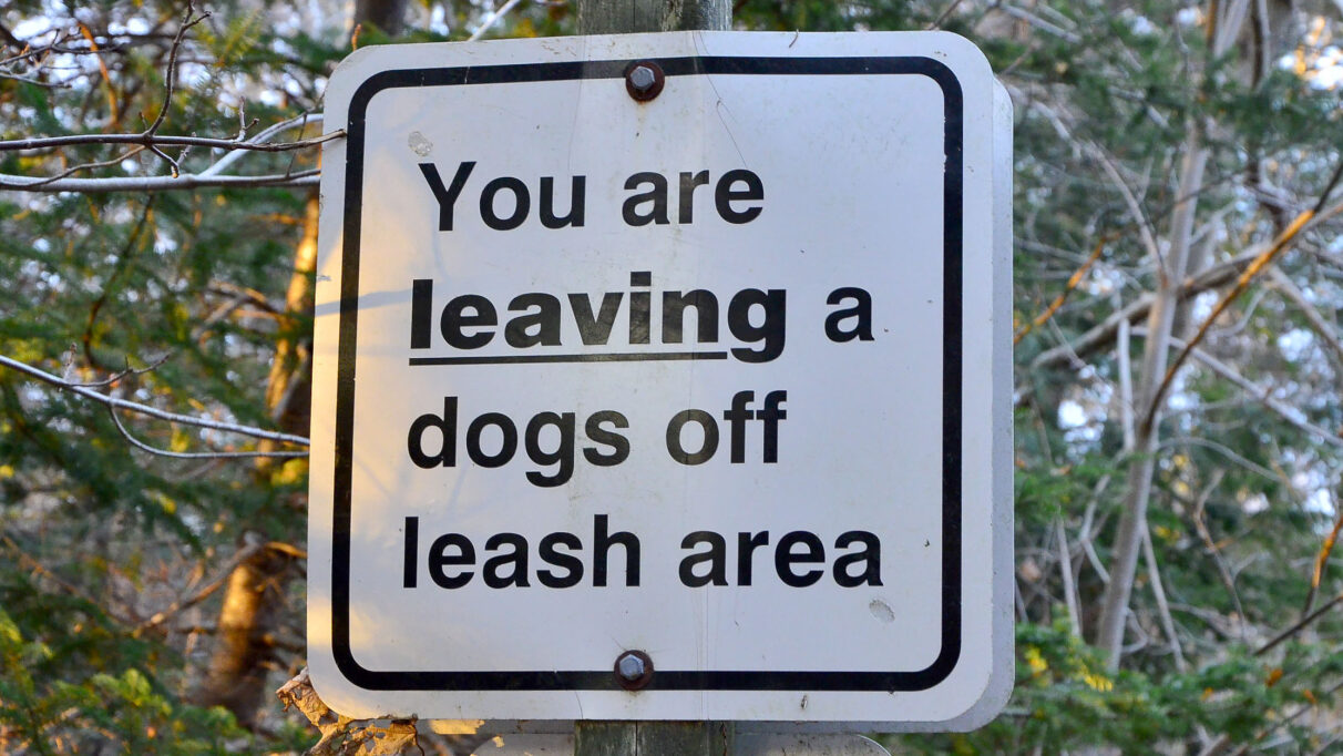 A sign that reads “You are leaving a dogs off leash area.”