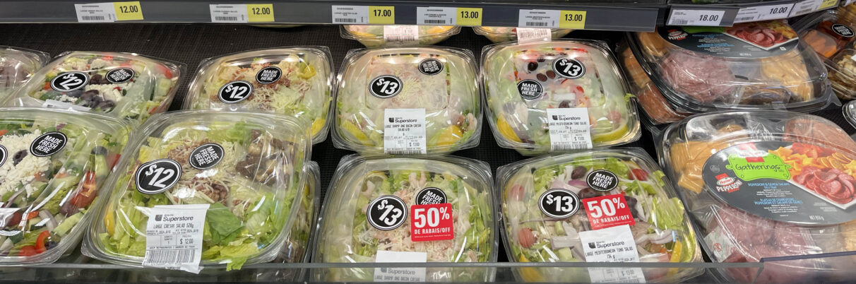 Salads are displayed at a grocery store