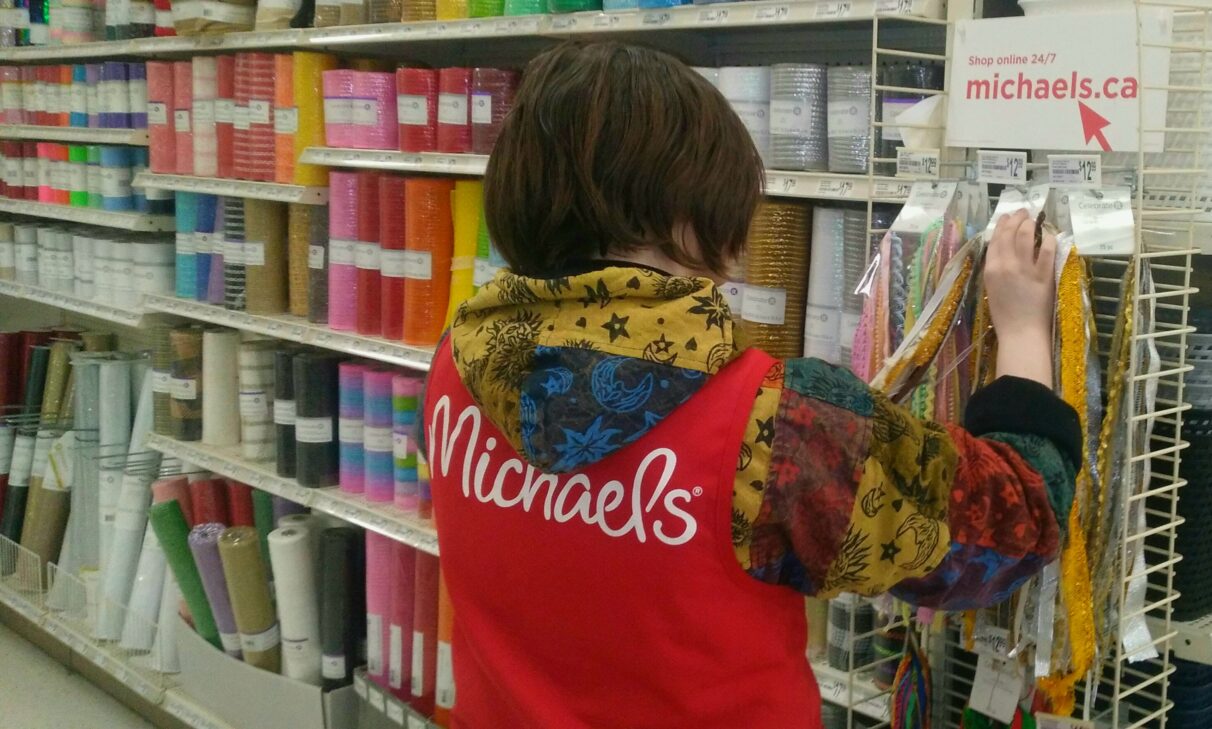 Store worker adjust ribbions at Michaels