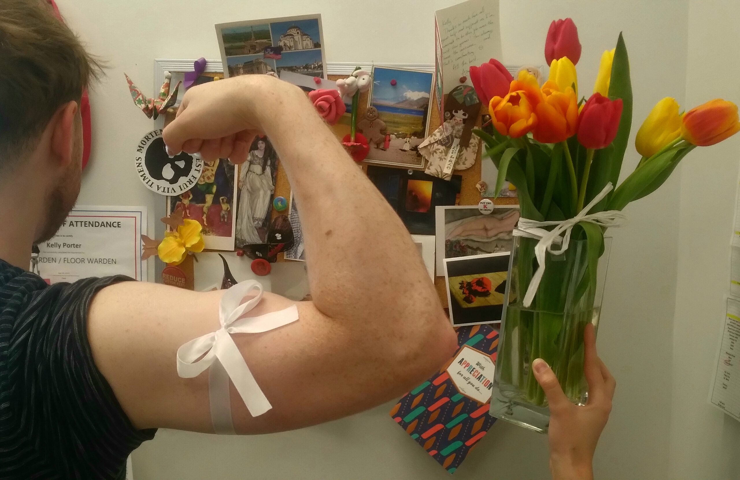 Males bicep with a ribbon around it. Tulips with a bow