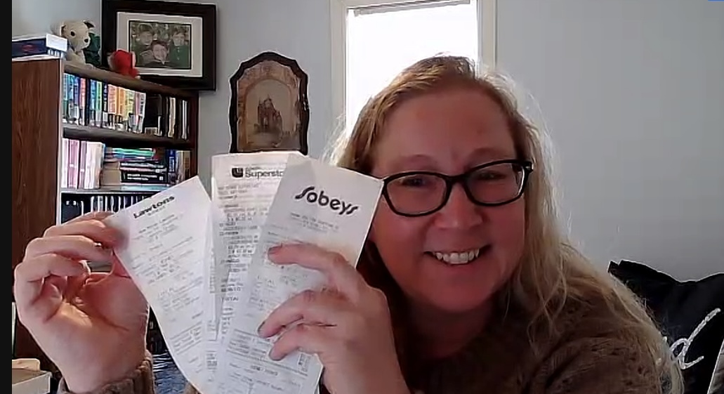 Woman shows her grocery shopping receipts.