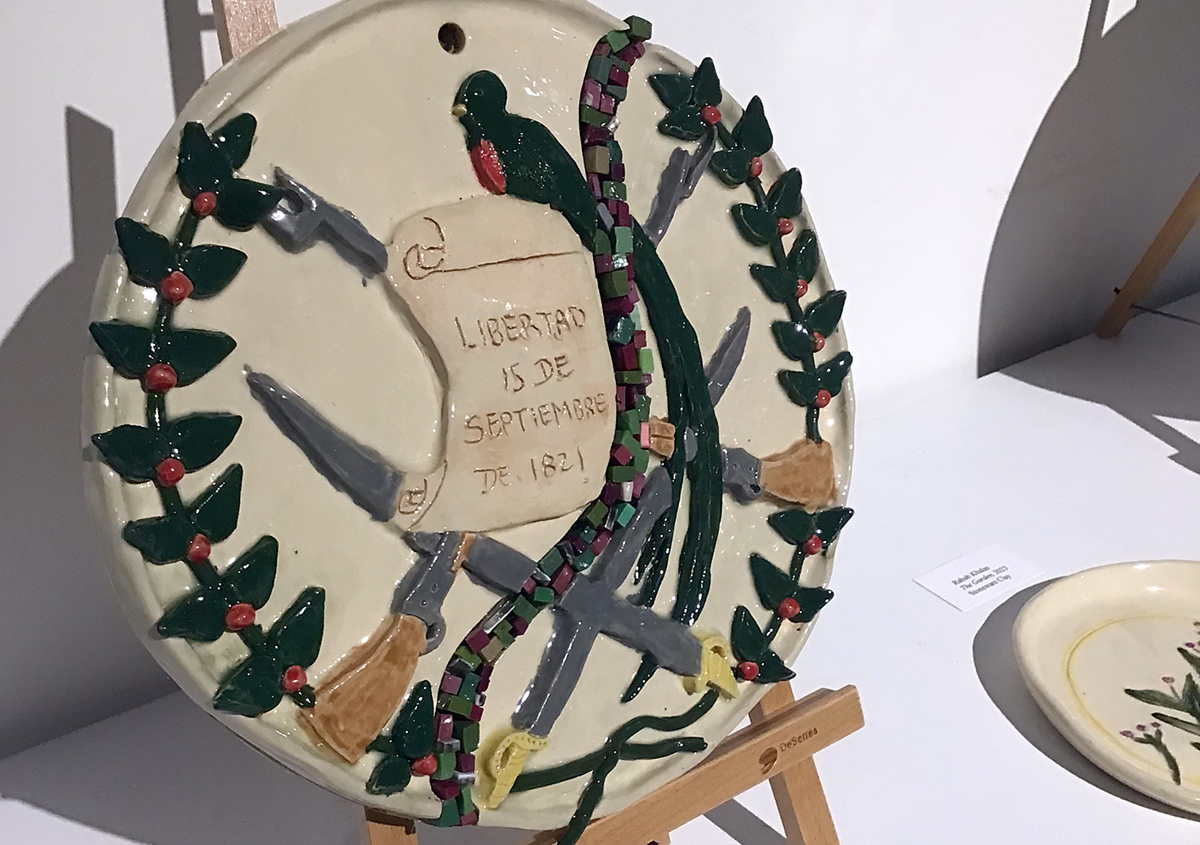 A circular clay piece of art with writing on it