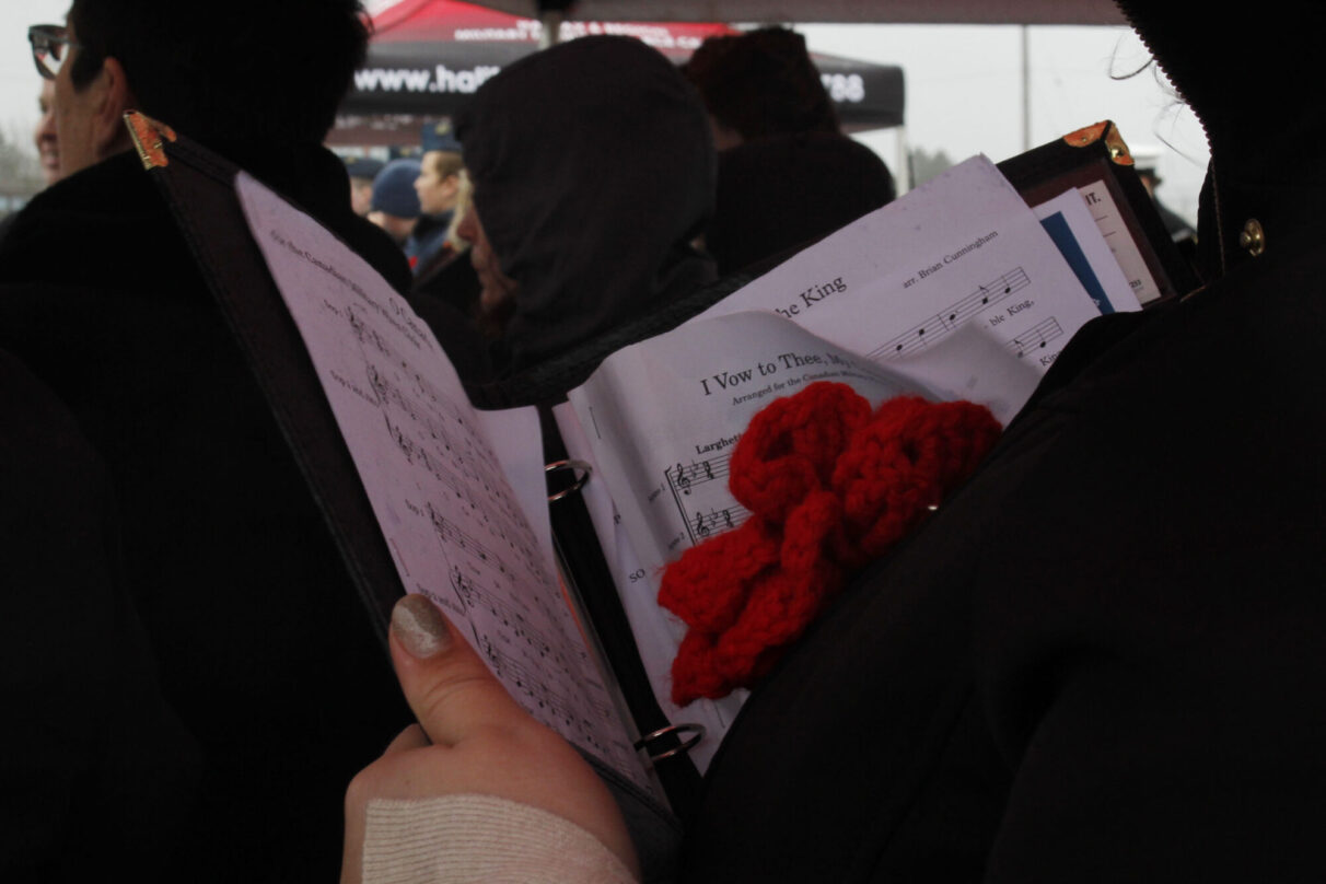 A close up on the sheet music the choir reads from.