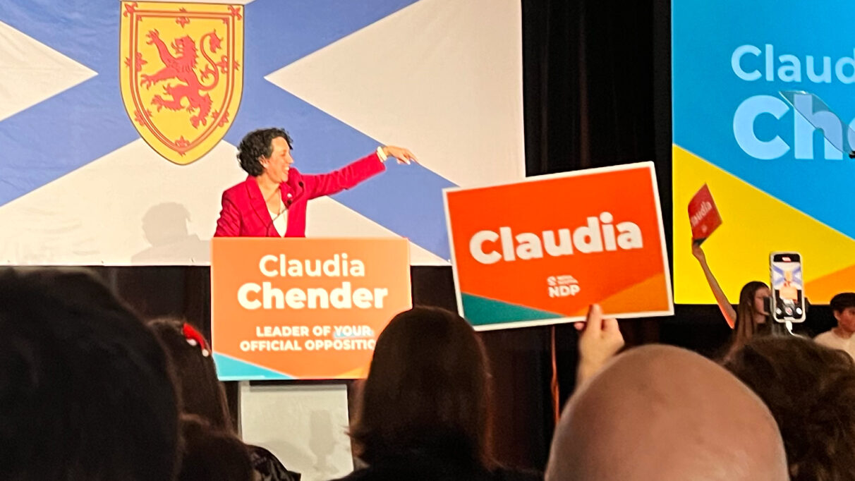 a woman gives a speech to a crowd