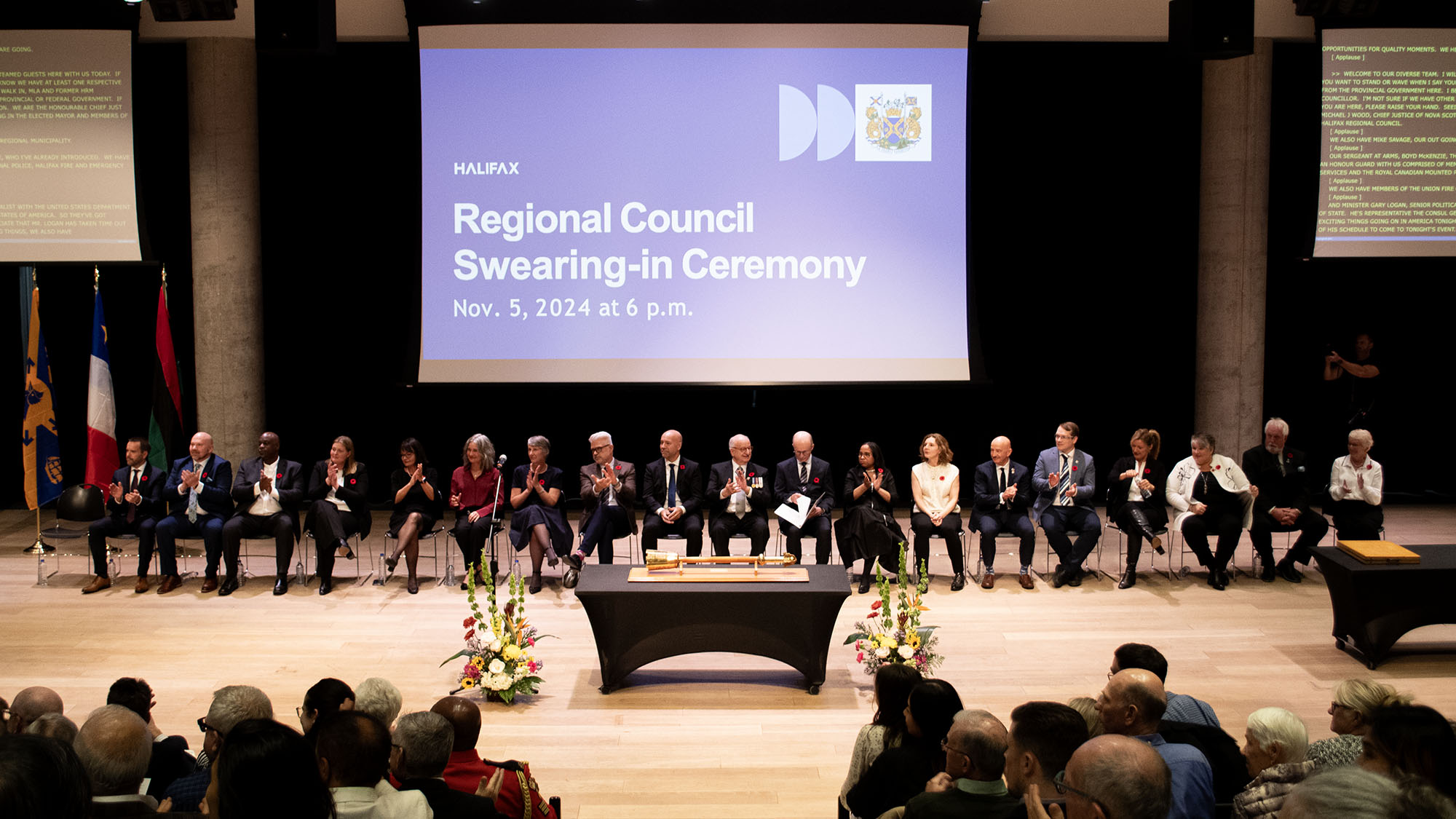 Council sits at the front of the room during the swearing in ceremony.