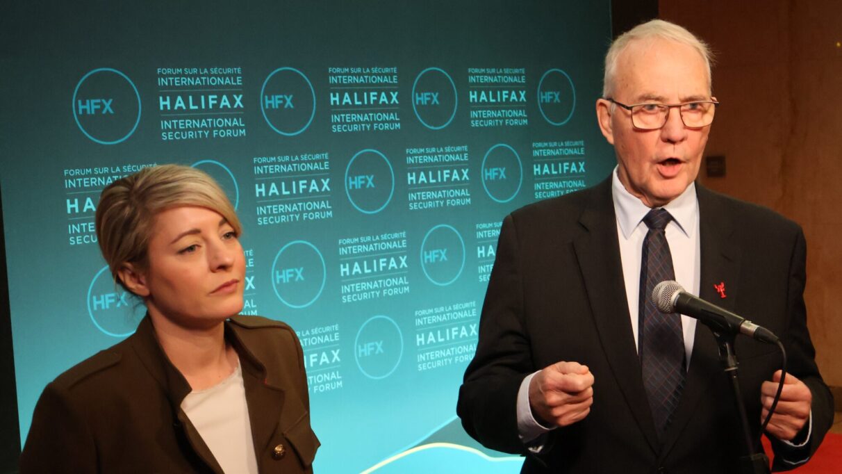 Melanie Joly and Bill Blaire address the press in front of an HFX forum photo background.