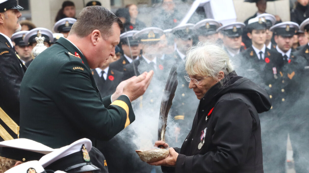 a woman and man perform a smudging ceremony