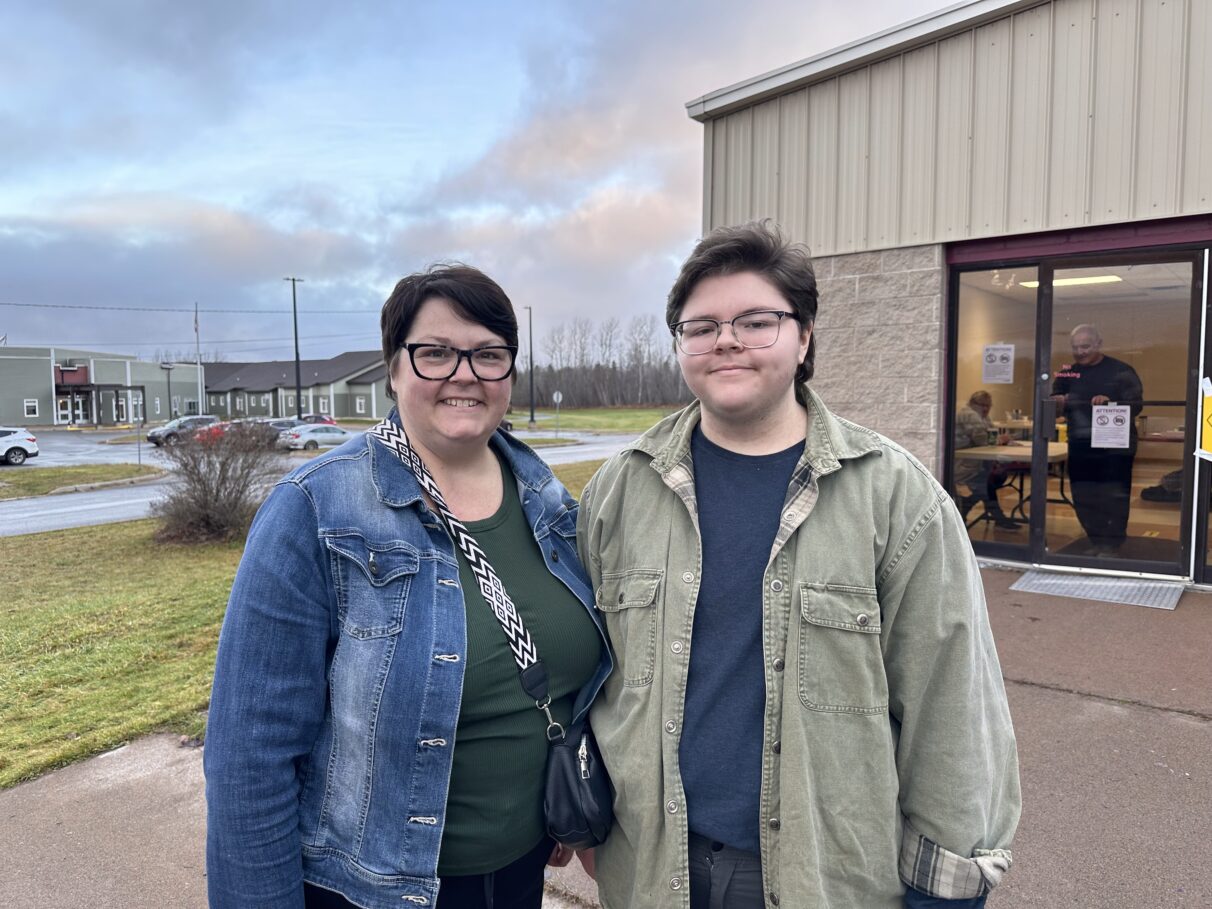 A mother and son outisde a polling station.