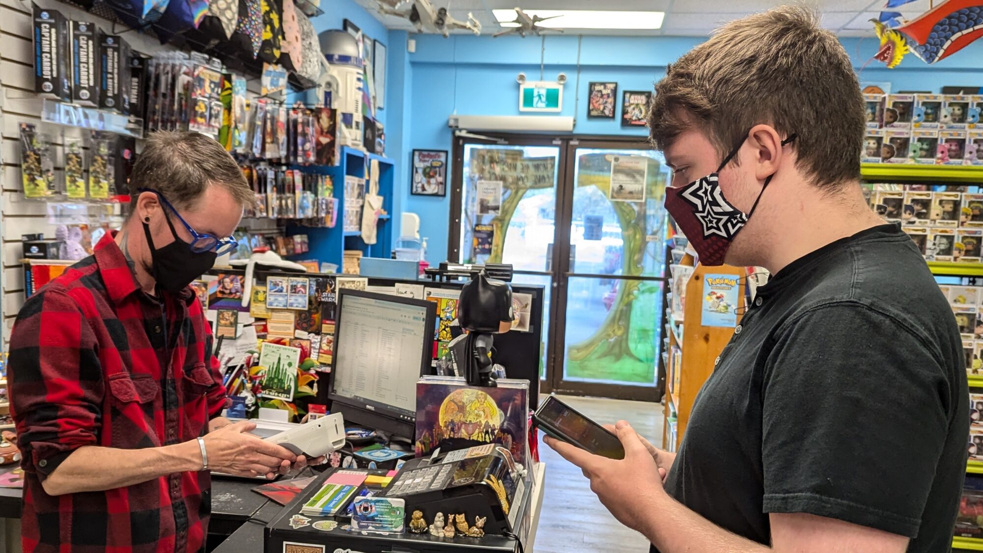 A person buying something from a store owner.