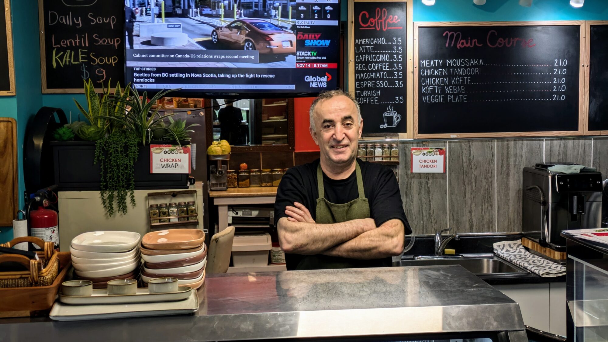 Chef Huseyin Temiz stands behind the counter in his cafe