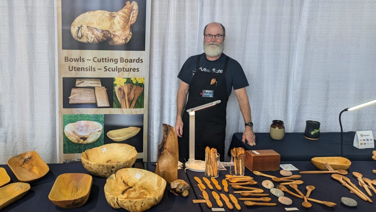 Andrew Tubman stands behind his woodworking products.