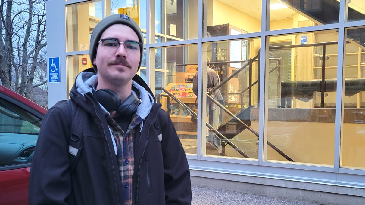 a man stands in front of a building