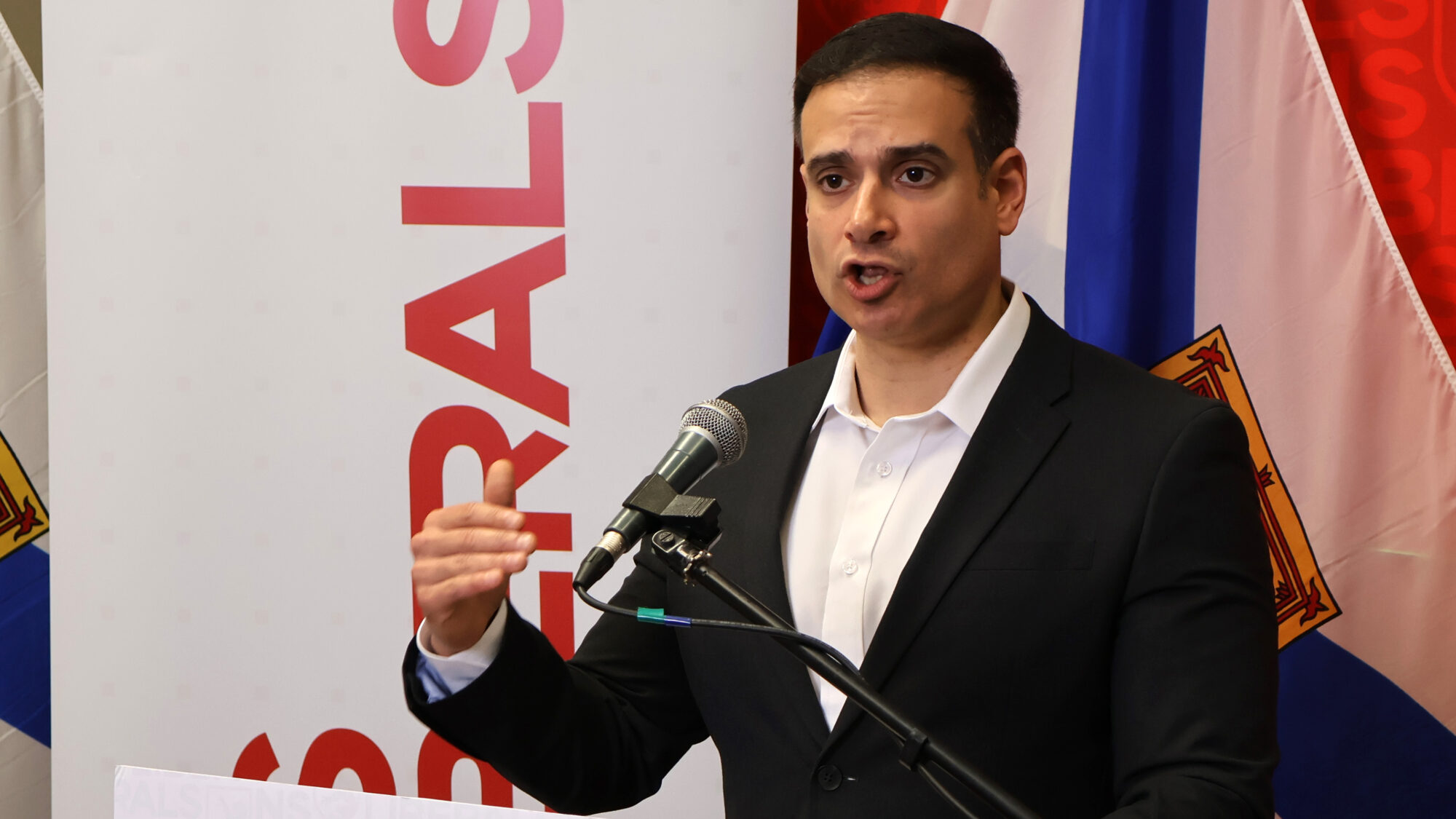 a man speaks at a podium