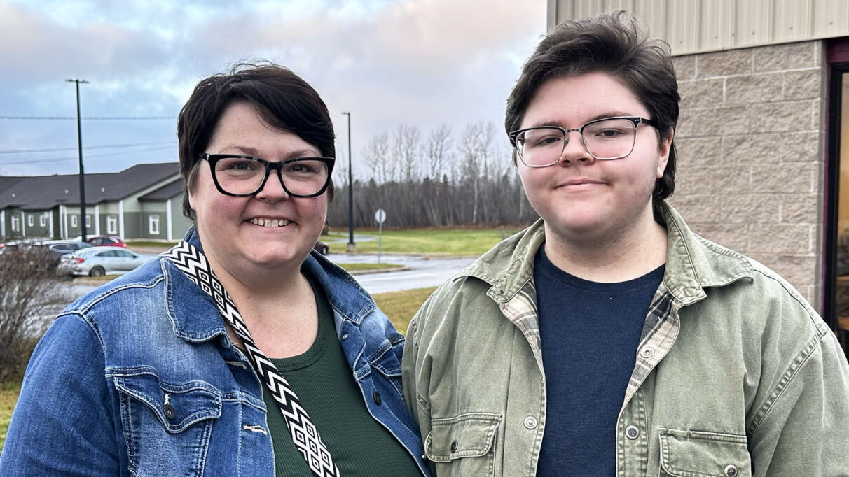 Mother and son smiling at camera