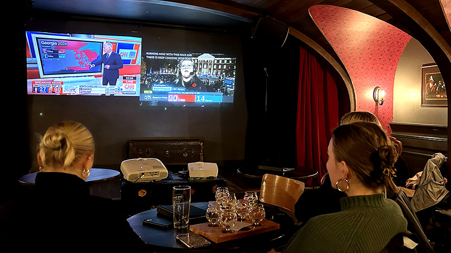 Three women watch election coverage