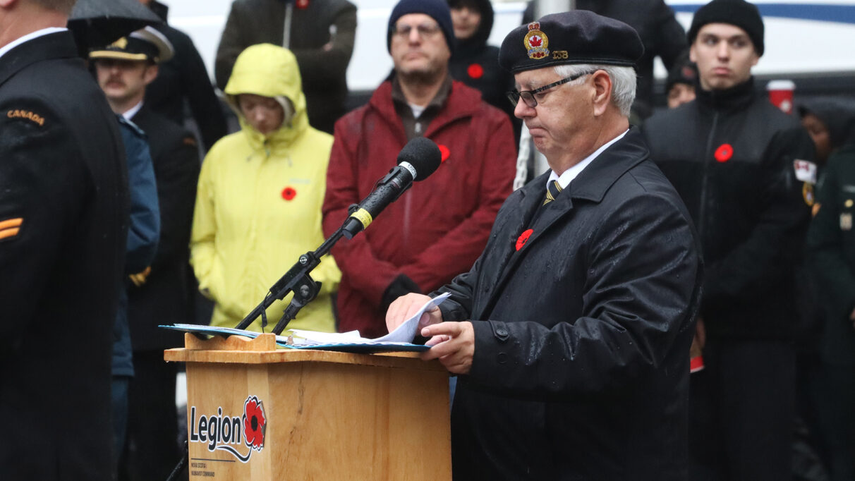 a man stands at a podium with a microphone