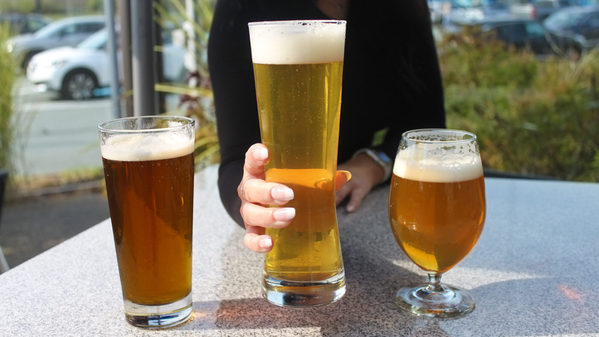 A person grabs a mug of beer.