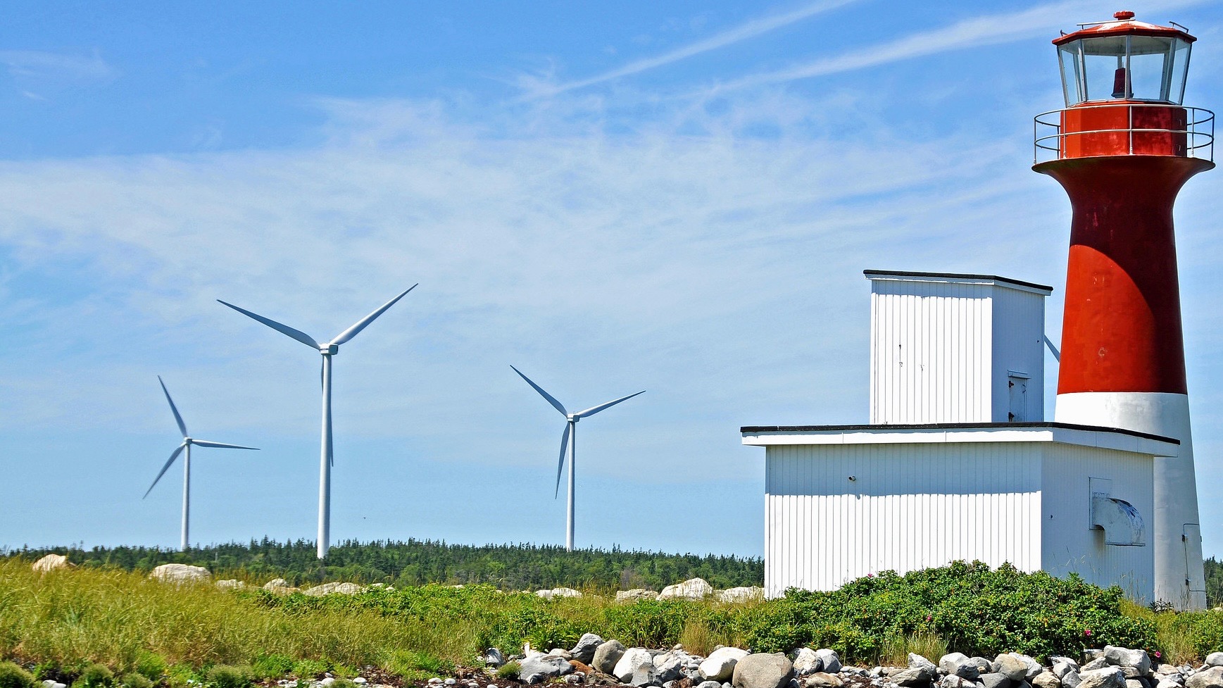 Wind turbines near red light house in Nova Scotia.