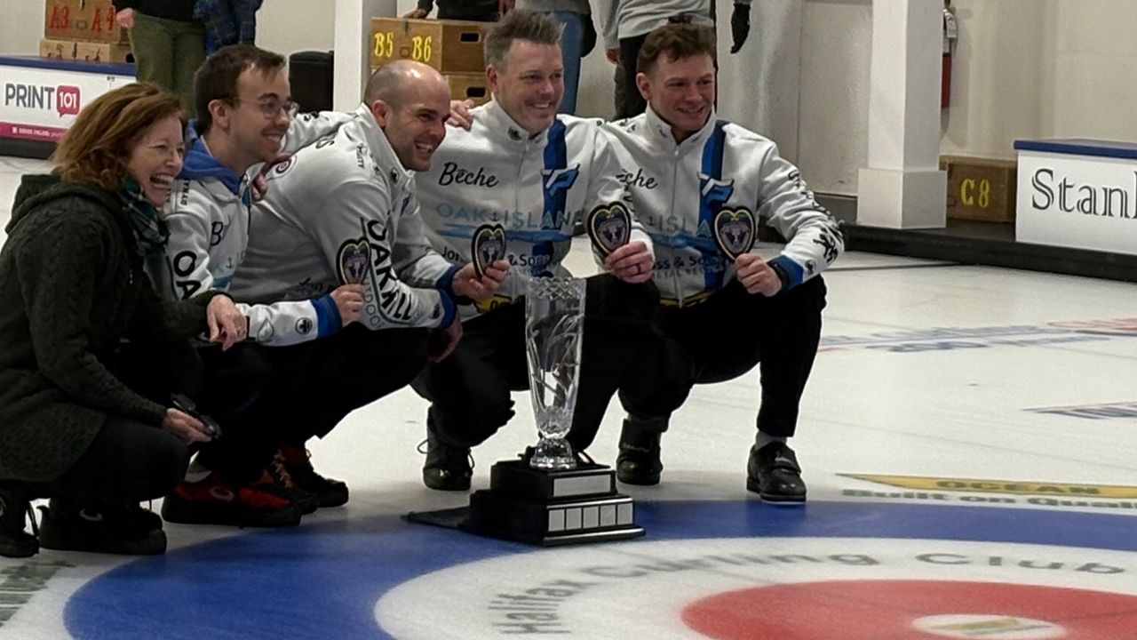 Team Purcell pose with a trophy after winning the Ocean Contractors Provincial Curling Championship.