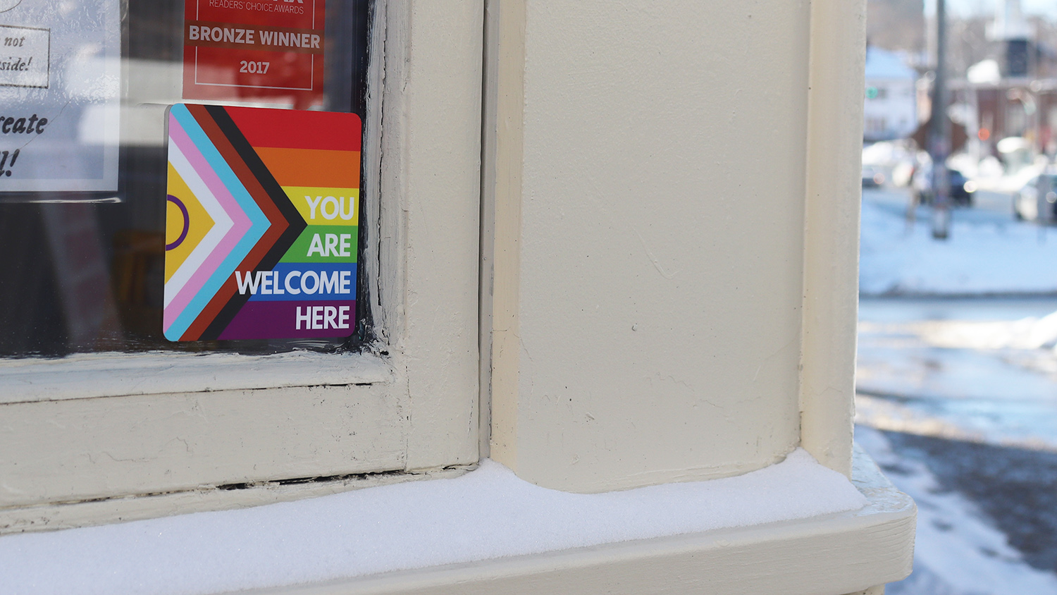 A welcoming pride sticker in the front window of Glitter Bean Cafe in Halifax on Feb 11, 2025. Owned and run by queer individuals, Glitter Bean Cafe was the target of alleged anti-trans graffiti. Photo by Marlo Ritchie