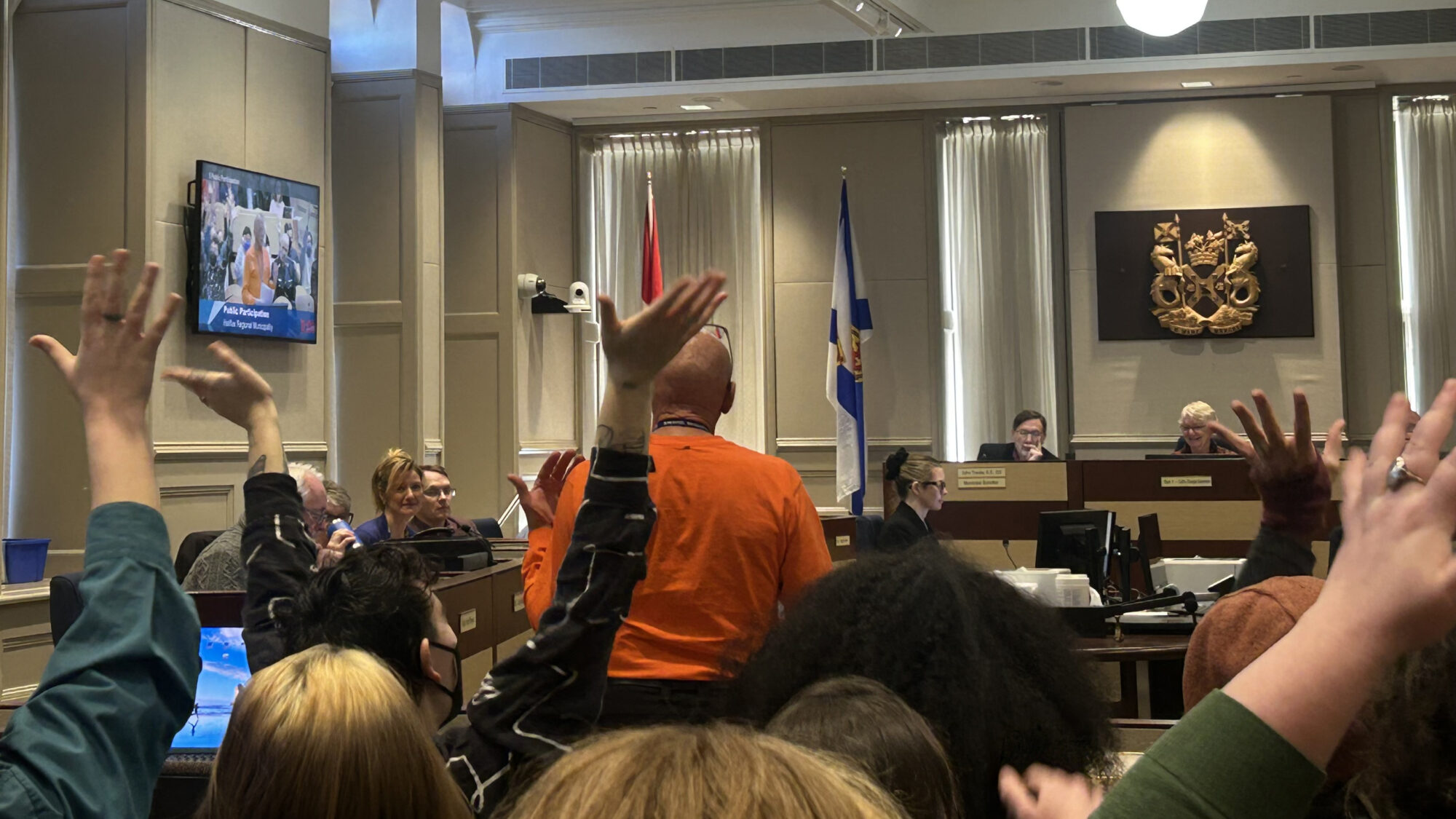 Silent applause for Ron Jeppesen from Community Not Cops Kjipuktuk during his presentation to Halifax City Hall’s Budget Committee on Wednesday, Feb. 12. Raising and shaking of hands represents clapping in ASL.