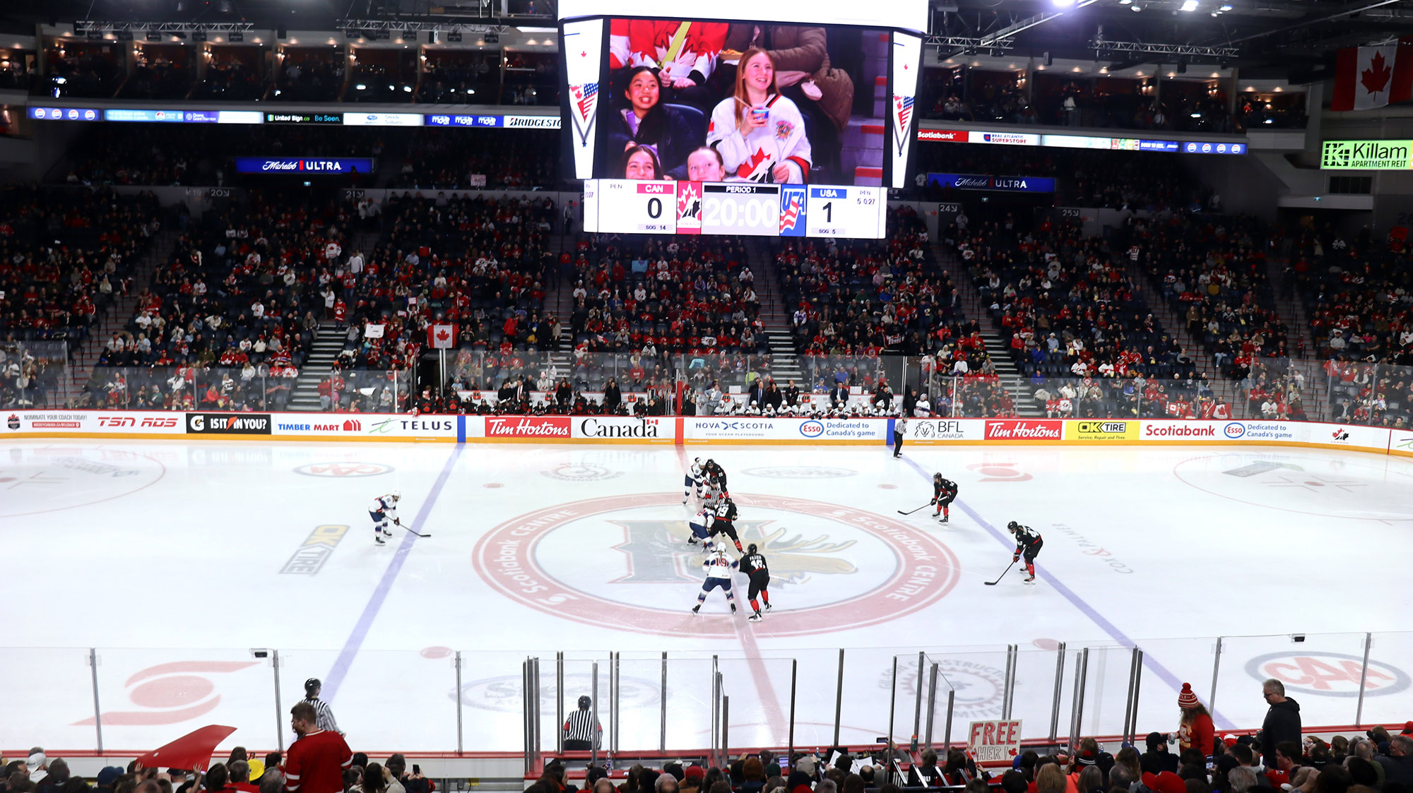 A hockey arena with players set to take a face-off at centre ice.