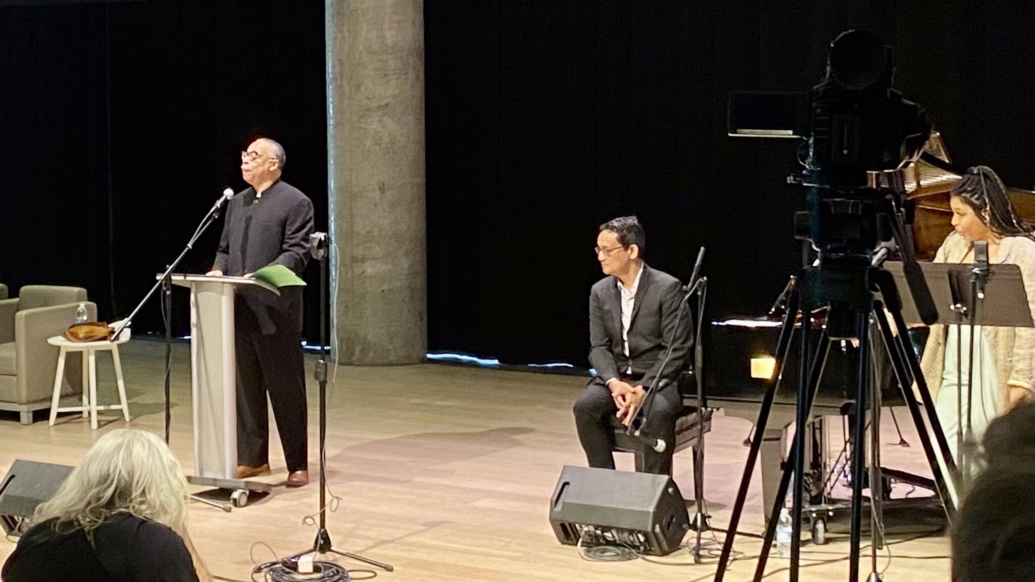 George Elliott Clarke speaking into a microphone at Halifax Central Library during an event