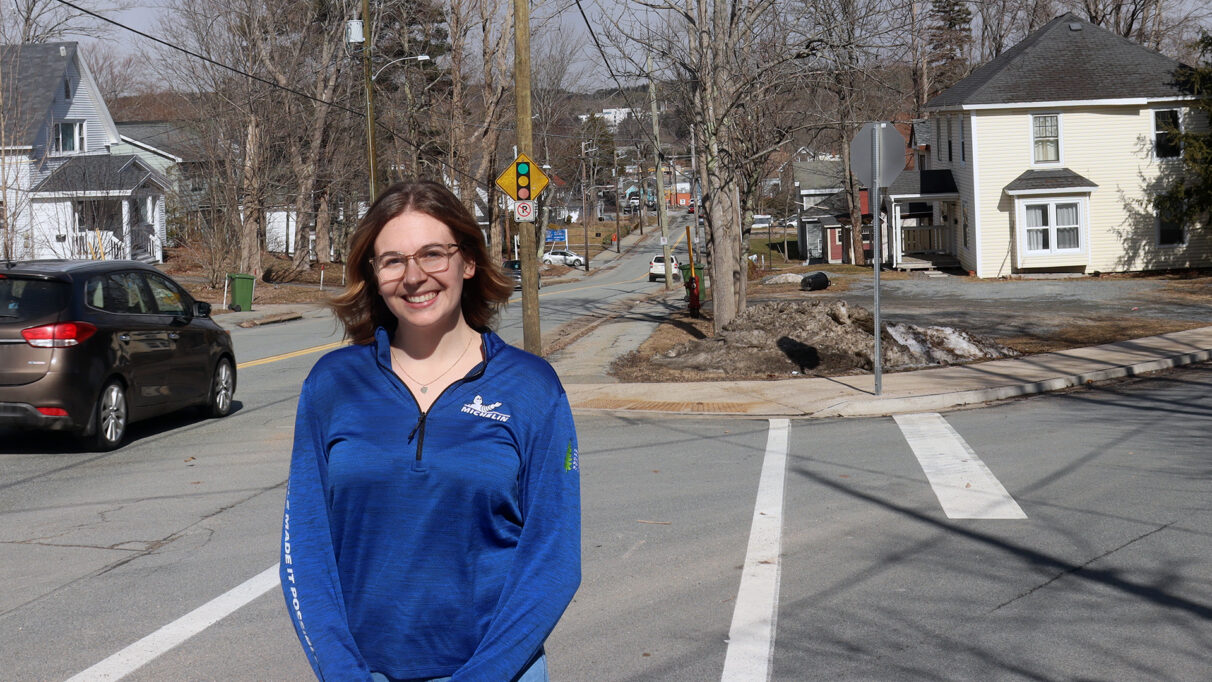 Mal Haley stands by a road in Bridgewater with the town in the background.
