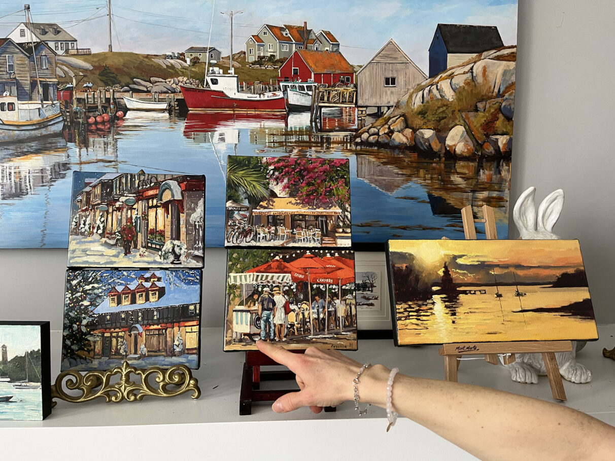 Evgenia Makogon points to her painting of The Bicycle Thief restaurant in Halifax, N.S., at her home in Bedford, Nova Scotia, on Sunday, March 2, 2025.