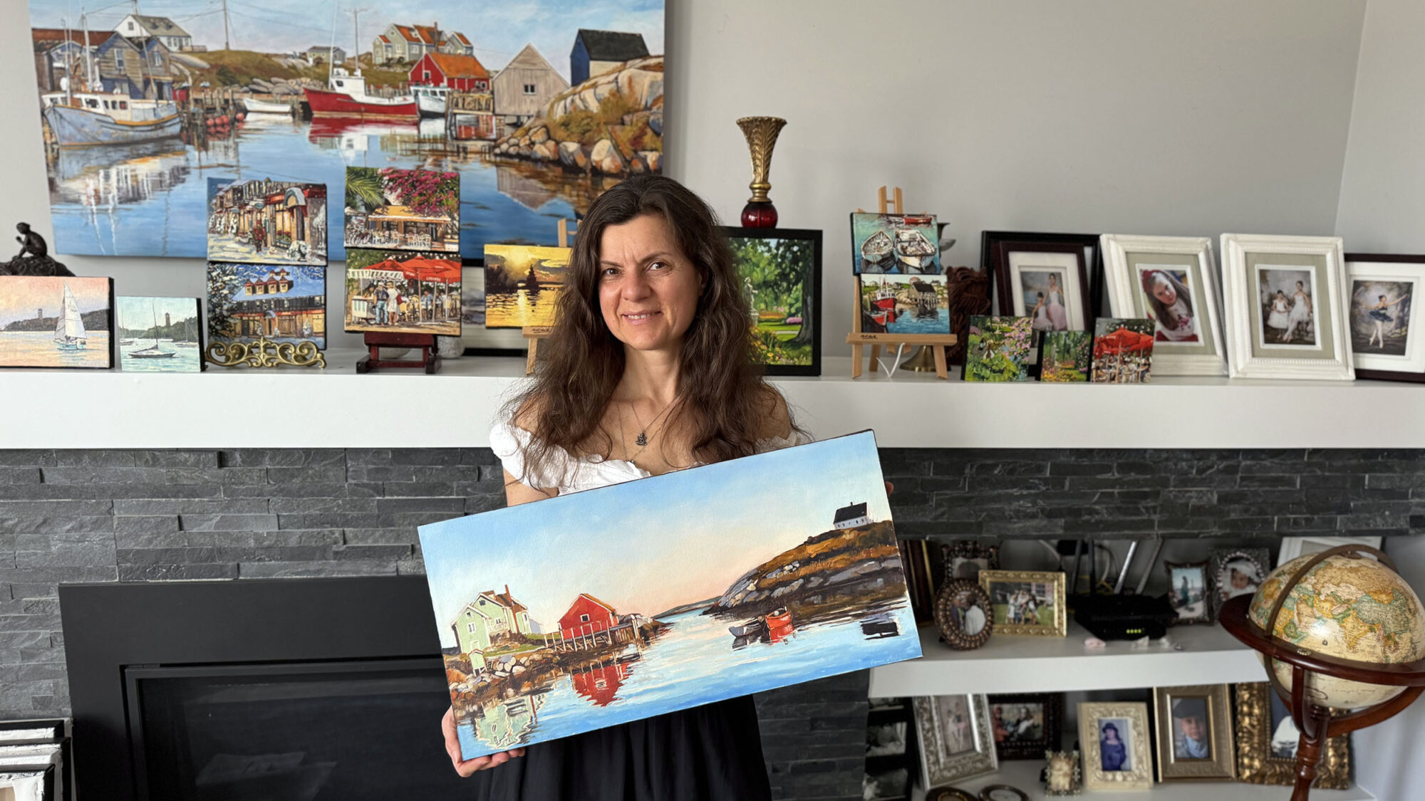 Evgenia Makogon poses with her painting Early Bright, which appears in the Hallmark movie Christmas Island, at her home in Bedford, Nova Scotia, on Sunday, March 2, 2025. (Photo by Zoe Wellings)